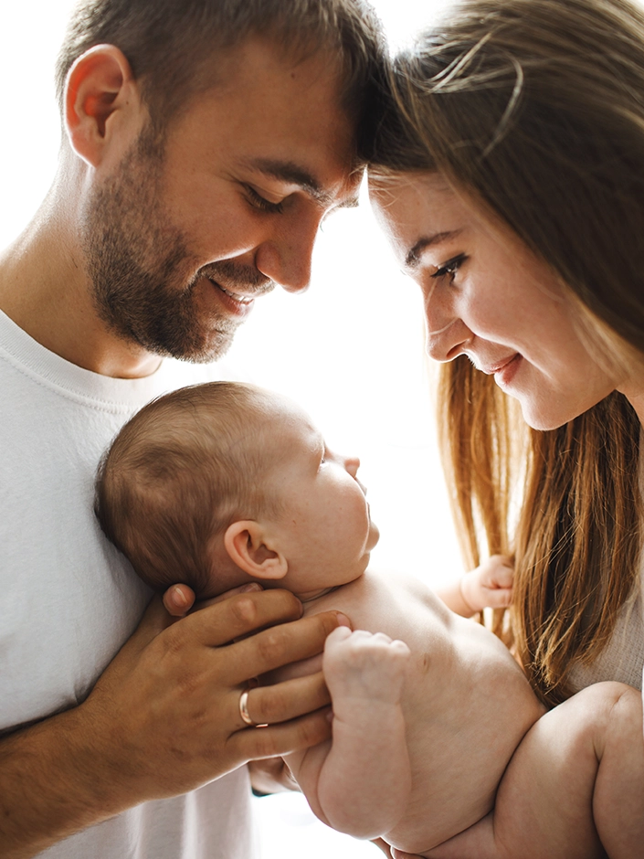 parents holding baby